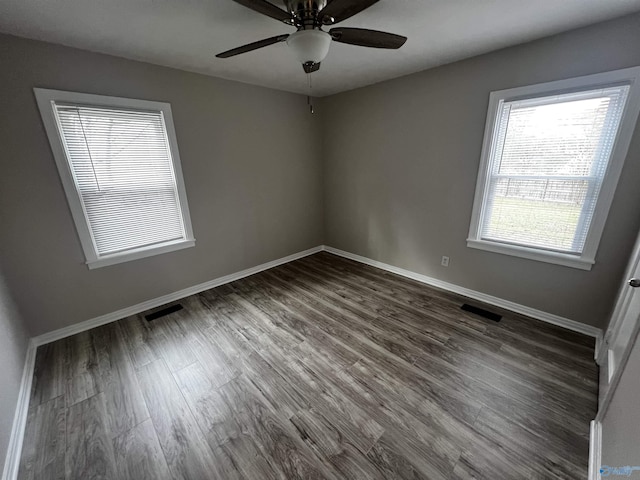 unfurnished room featuring ceiling fan and dark wood-type flooring