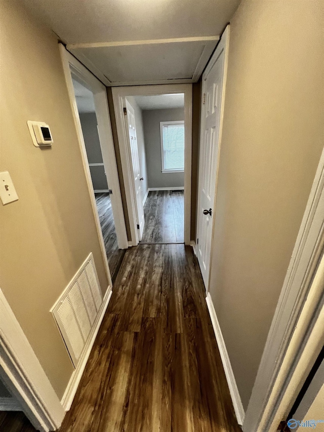 corridor with dark hardwood / wood-style floors