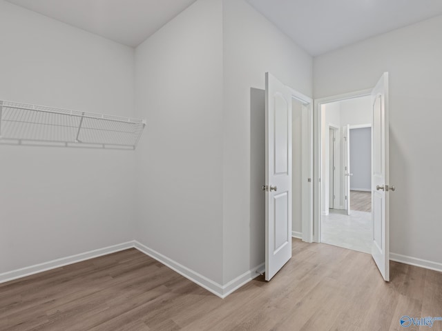 interior space featuring baseboards and light wood-type flooring