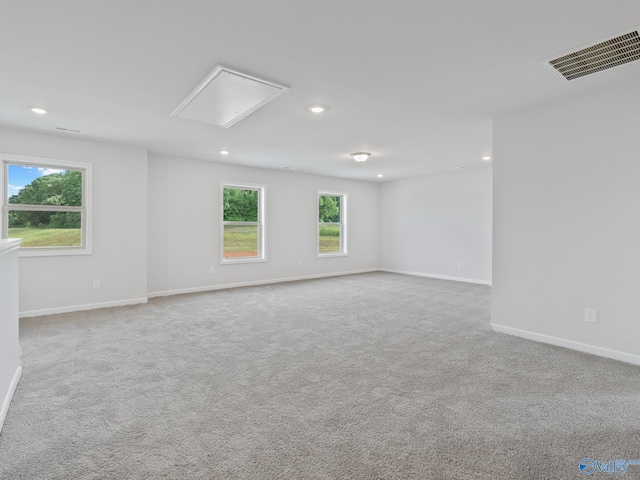 empty room featuring baseboards, recessed lighting, attic access, visible vents, and carpet