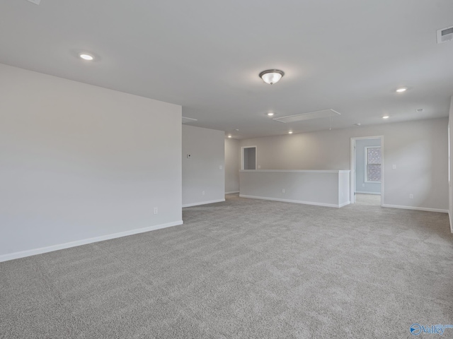unfurnished room with recessed lighting, visible vents, baseboards, and attic access
