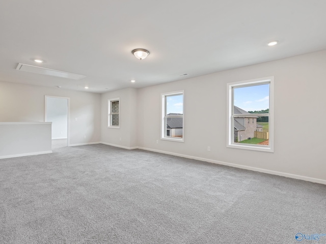 empty room featuring carpet floors, baseboards, recessed lighting, and attic access