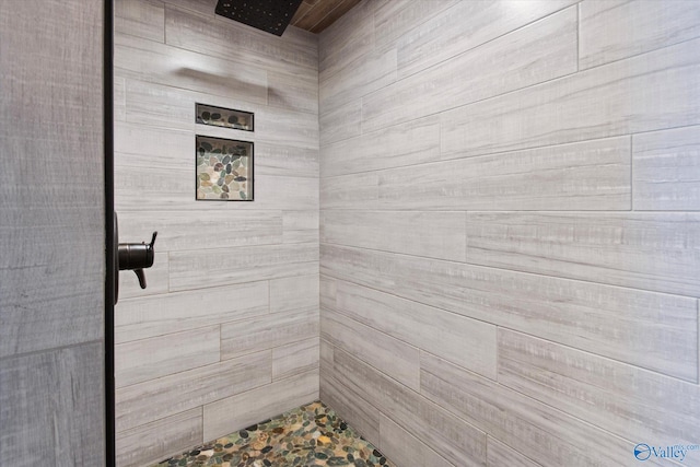 bathroom with a tile shower