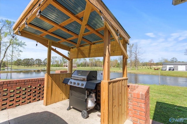 view of patio with a water view and a grill