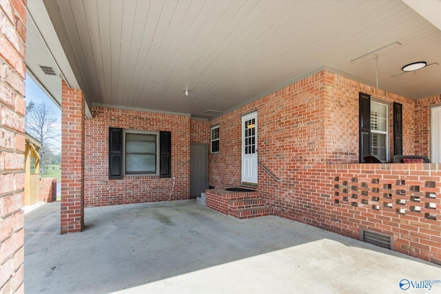 view of patio / terrace featuring an attached carport and visible vents