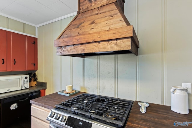 kitchen featuring red cabinets, stainless steel gas stove, dishwasher, white microwave, and custom exhaust hood
