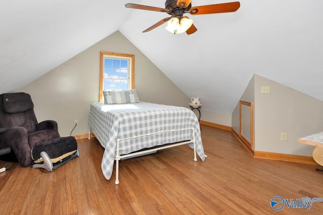 bedroom featuring vaulted ceiling, hardwood / wood-style floors, and ceiling fan