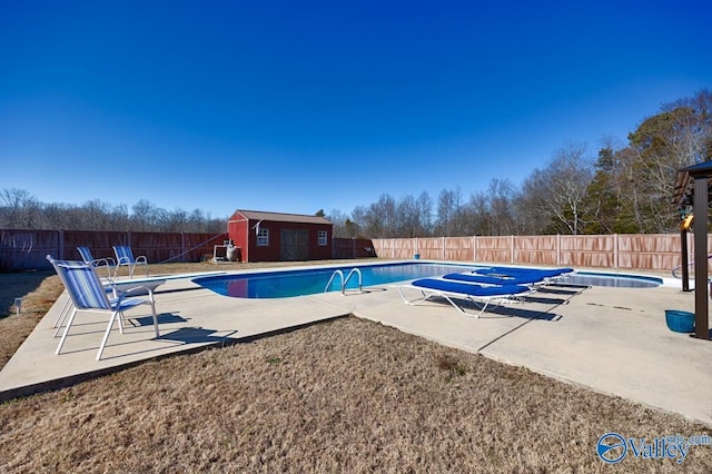 view of swimming pool featuring an outdoor structure and a patio area