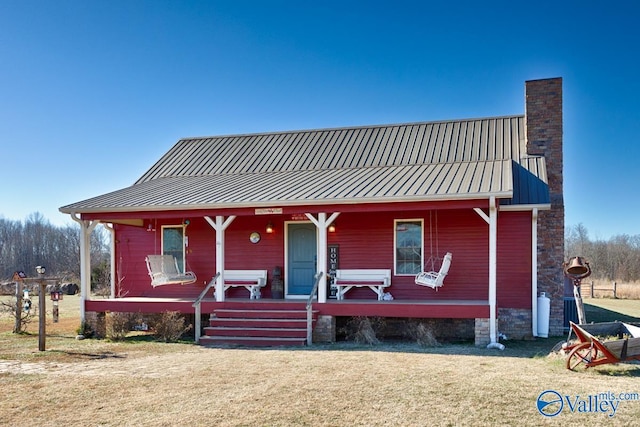 view of front of home with a porch and a front yard