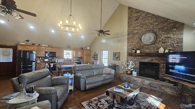 living room with sink, high vaulted ceiling, a brick fireplace, dark hardwood / wood-style floors, and ceiling fan with notable chandelier