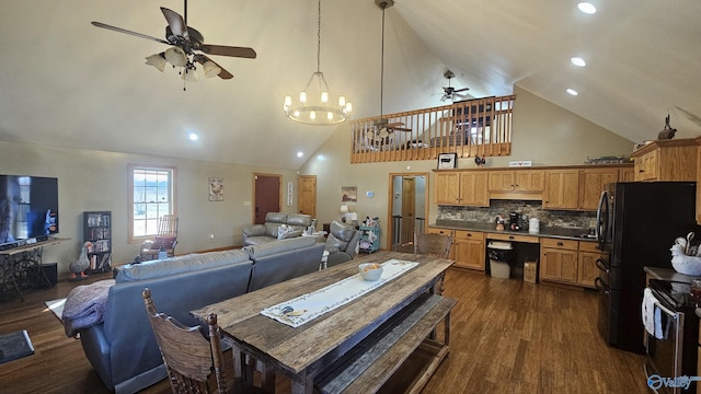 dining area with dark hardwood / wood-style flooring, ceiling fan with notable chandelier, and high vaulted ceiling