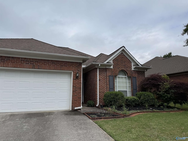 504 Sussex Dr SW, Huntsville, AL 35824 - view of front facade featuring brick siding, driveway, roof with shingles, a front yard, and a garage