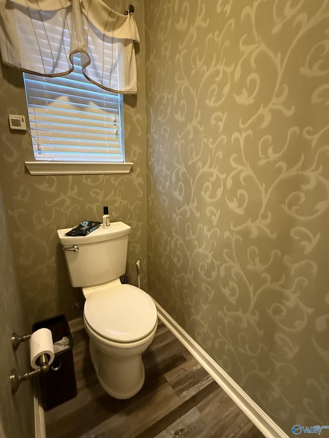 504 Sussex Dr SW, Huntsville, AL 35824 - half bathroom with wallpapered walls, wood finished floors, toilet, and baseboards