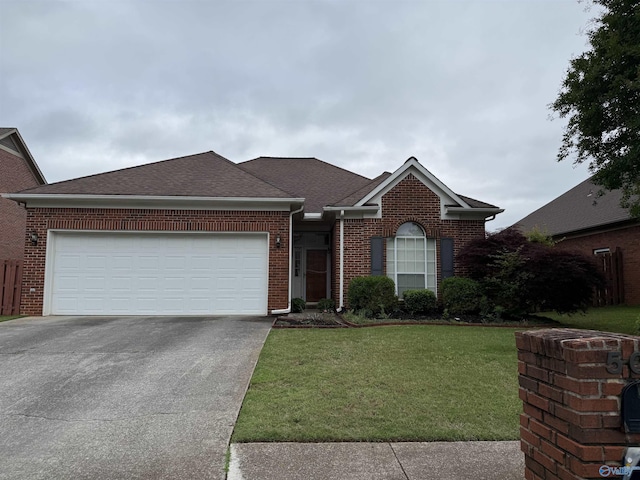 504 Sussex Dr SW, Huntsville, AL 35824 - view of front of house featuring concrete driveway, brick siding, a front yard, an attached garage, and a shingled roof