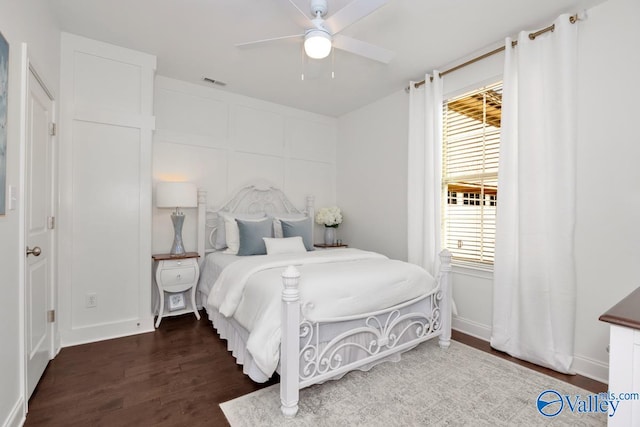 bedroom with ceiling fan and dark hardwood / wood-style floors