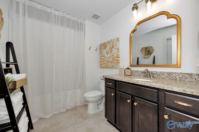 bathroom with vanity, tile patterned flooring, and toilet