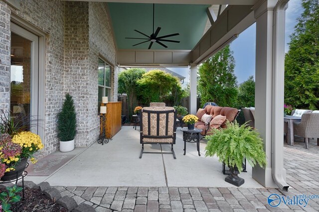 living room featuring a brick fireplace, hardwood / wood-style flooring, vaulted ceiling, and built in shelves