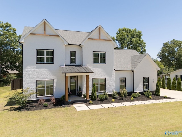 modern farmhouse style home with a front lawn