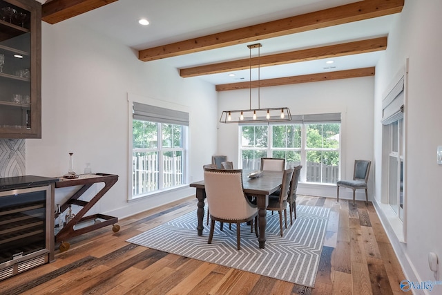 dining area featuring beamed ceiling and wood-type flooring