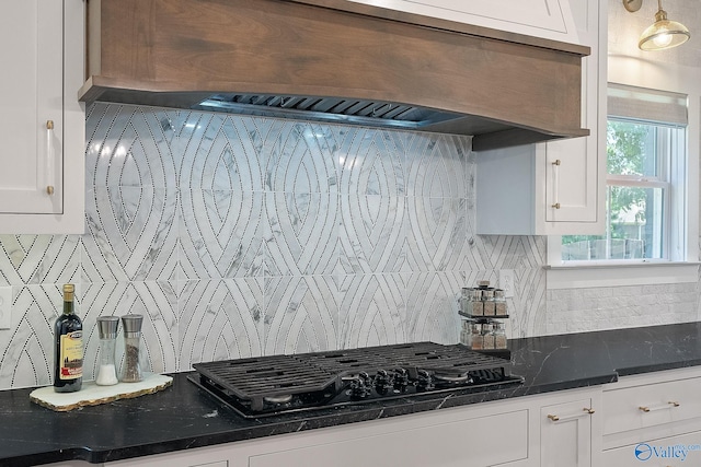 kitchen featuring white cabinetry, custom exhaust hood, tasteful backsplash, and black gas cooktop