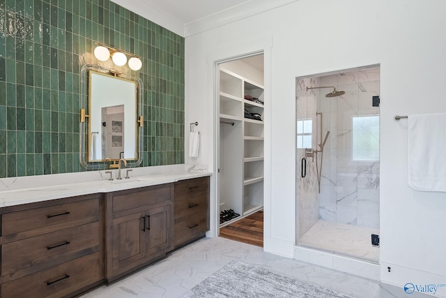 bathroom with vanity, tile patterned floors, tile walls, ornamental molding, and a shower with door