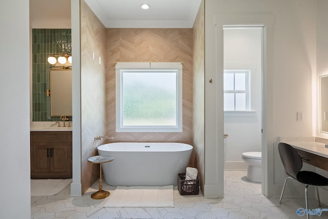 bathroom with a wealth of natural light, vanity, toilet, and tile patterned floors