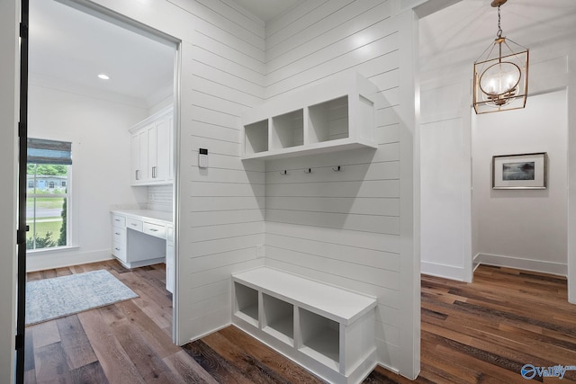 mudroom featuring dark hardwood / wood-style floors, a notable chandelier, and ornamental molding