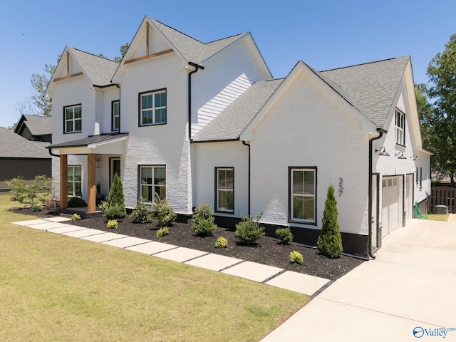 view of front of house featuring a garage and a front lawn