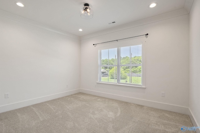 unfurnished room featuring light colored carpet