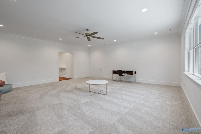 unfurnished room with crown molding, ceiling fan, and light colored carpet