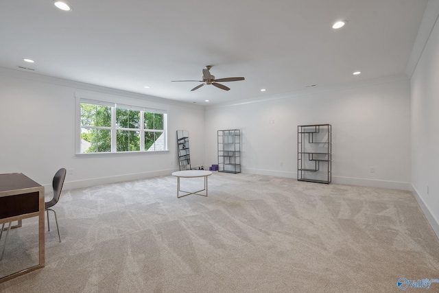 interior space featuring ceiling fan, light colored carpet, and ornamental molding