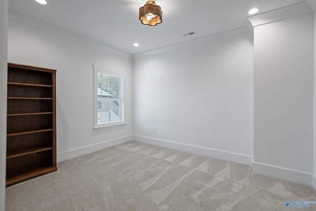 spare room with carpet flooring and crown molding