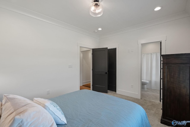 carpeted bedroom with ensuite bath