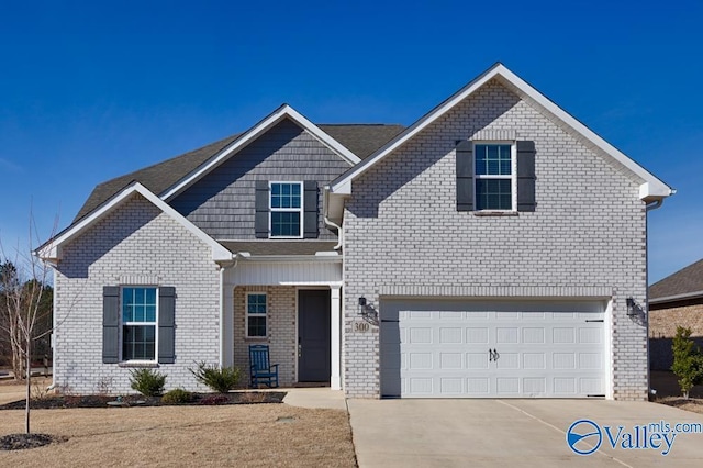 traditional-style house with brick siding, driveway, and an attached garage