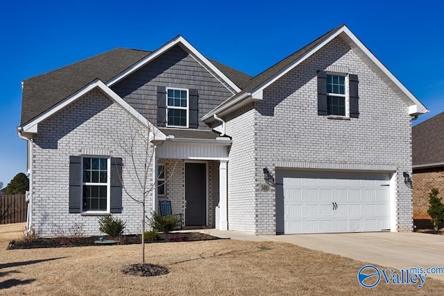 traditional-style house with a garage, driveway, and brick siding