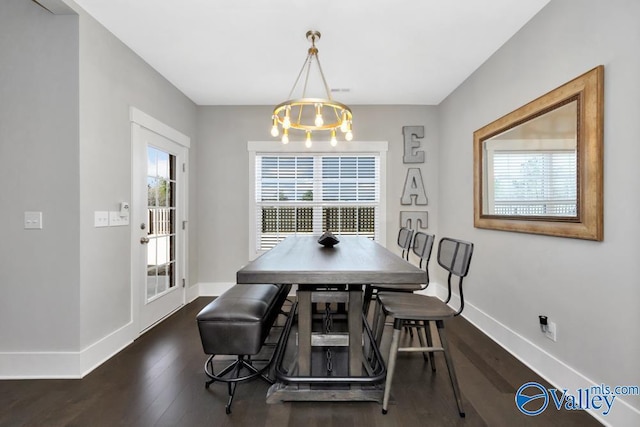 dining room featuring an inviting chandelier and dark hardwood / wood-style floors