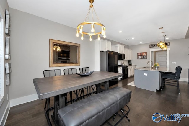 dining space featuring dark hardwood / wood-style floors and sink