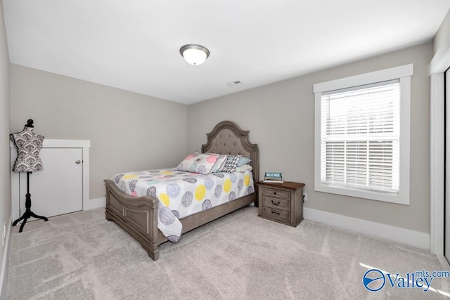 bedroom featuring light carpet