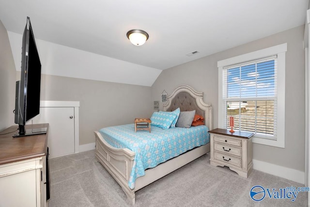 carpeted bedroom featuring vaulted ceiling