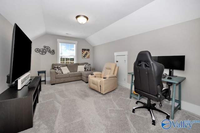 office featuring vaulted ceiling and light carpet