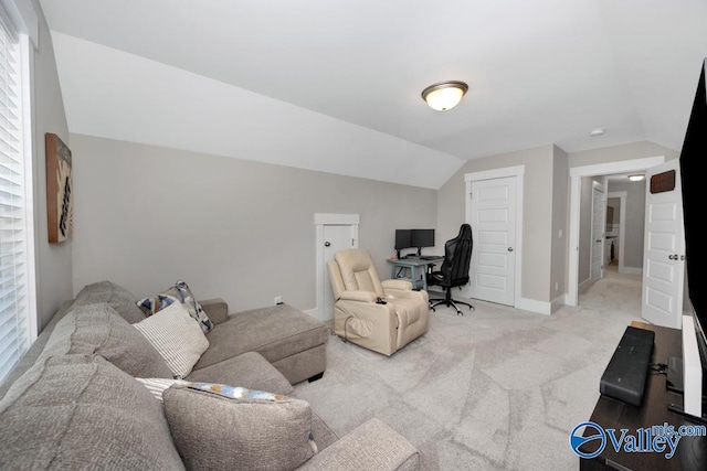 carpeted office featuring vaulted ceiling