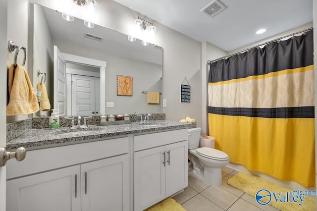 bathroom with vanity, curtained shower, tile patterned floors, and toilet