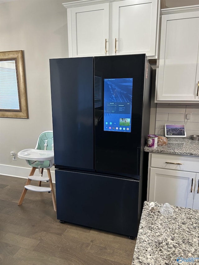 kitchen featuring white cabinets, smart refrigerator, and light stone countertops