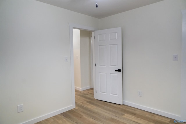 spare room with light hardwood / wood-style flooring