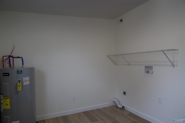 washroom featuring light hardwood / wood-style floors, hookup for a washing machine, electric water heater, and electric dryer hookup