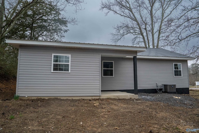 view of side of home featuring central AC unit