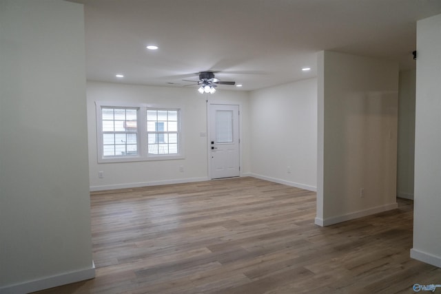 unfurnished room featuring ceiling fan and light hardwood / wood-style flooring
