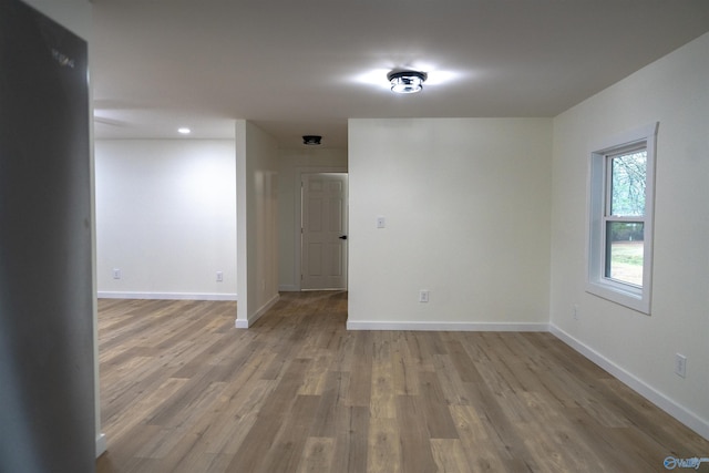 empty room with hardwood / wood-style flooring