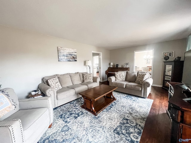 living room featuring dark hardwood / wood-style flooring and a notable chandelier