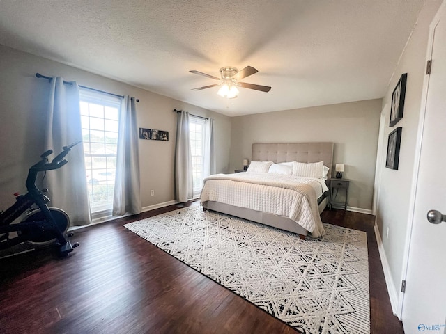 bedroom with ceiling fan, hardwood / wood-style floors, and a textured ceiling